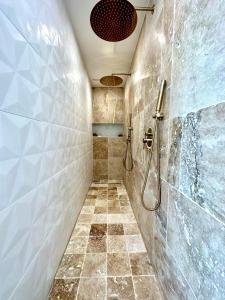 a bathroom with a shower and a tiled floor at Charmante Maison La Libournaise +parking in Libourne +27 photos