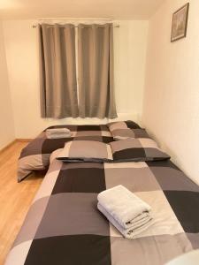 a room with two beds with towels on them at T2D Apartment - Suite BLG proche Disneyland Paris in Bussy-Saint-Georges