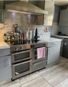 a kitchen with a stainless steel stove top oven at Hidden Gem in Great Parndon