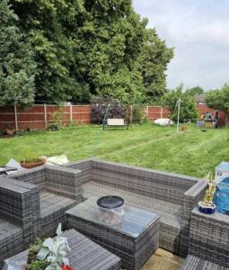 a backyard with a brick patio with a lawn at Hidden Gem in Great Parndon