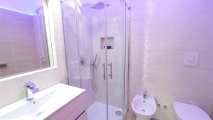 a bathroom with a shower and a toilet and a sink at Residence Maresol in Vieste