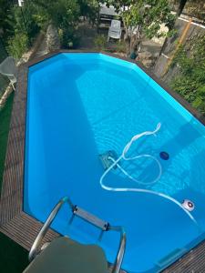 a blue swimming pool with a chair in it at Al Qatta Bed & Breakfast in Canicattì