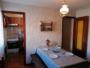 a table with plates and glasses on it in a kitchen at Appartement Le Grand-Bornand, 1 pièce, 5 personnes - FR-1-241-202 in Le Grand-Bornand