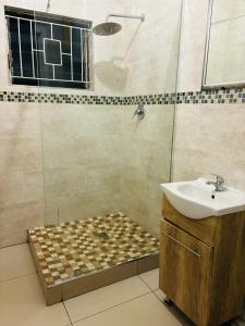 a bathroom with a sink and a shower at Gardenlea in Durban