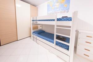 a bunk bed in a room with blue beds at Deluxe finestra sul lago in Bellano