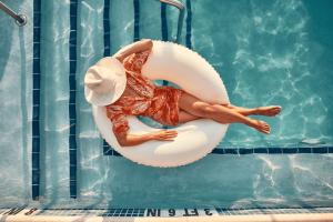 a woman in a hat is sitting on an inflatable at Virgin Hotels Nashville in Nashville