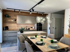 a kitchen and dining room with a table and chairs at Das Genner - Boutique Appartement in Tauplitz