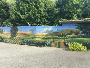 a mural of a garden on a wall at L'auberge fleurie in Heilly