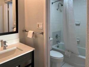 a bathroom with a sink and a toilet and a shower at Motel 6 Port Lavaca, TX in Port Lavaca