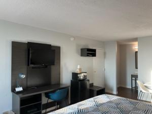 a hotel room with a bed and a desk with a television at Motel 6 Port Lavaca, TX in Port Lavaca