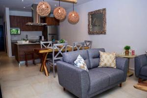 a living room with a couch and a table at New Modern Condo in Playa del Carmen in Playa del Carmen