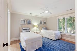 a bedroom with two beds and a blue rug at 335 Winged Foot in Kiawah Island