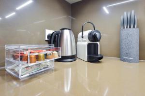 a kitchen counter with a coffee maker and sidx sidx sidx at Soho Deluxe 1 Bedroom Apartment by Concept Apartments in London