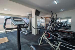 a gym with a treadmill and bikes in a room at Hotel Golden Park Curitiba in Curitiba