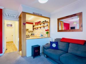 a living room with a couch and a kitchen at Cosy Victorian Apartment - Central York in York