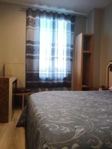 a bedroom with a bed and a window at hotel azur in Paris