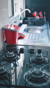 a stove top oven with a pot on top of it at Casa de Praia Beira Mar Bali Beach House in Bertioga