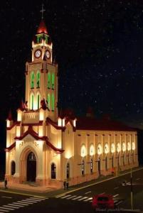 a large building with a clock tower at night at Hostal Camu Camu in Iquitos