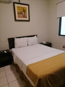 a bedroom with a large bed in a room at Hostal Camu Camu in Iquitos