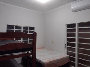 מיטה או מיטות בחדר ב-Piscina Aquecida, Ar condicionado Casa Inteira,Caminhos da Canastra