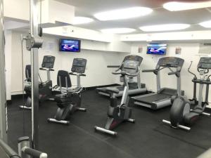 a gym with several exercise bikes in a room at New Modern Gorgeous Views Full Kitchen Waikiki in Honolulu