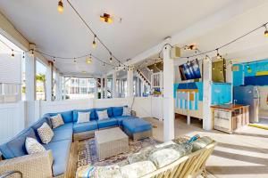 a living room with a blue couch and a play area at All Decked Out in Ocean Isle Beach