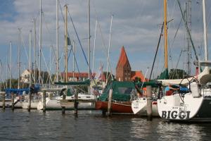 a group of boats docked at a dock in the water at Ferienwohnungen Alter Bahnhof mit Terrasse und Garten OFC 06 in Roggow