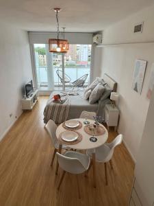 a room with a bed and a table and chairs at Amazing Studio in San Telmo with River view in Buenos Aires