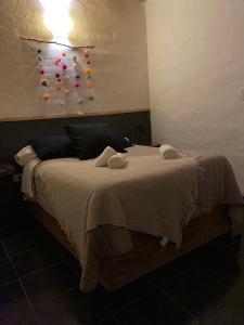 a bedroom with a bed with a wall with pins at San Julián in San Rafael