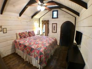 a bedroom with a bed and a ceiling fan at Tiny Home Cottage Near the Smokies #11 Mina in Sevierville