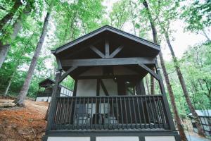 a tree house in the middle of the woods at Tiny Home Cottage Near the Smokies #11 Mina in Sevierville