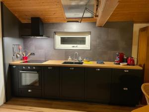 a kitchen with a sink and a stove at The Old Barn in Hoevelaken