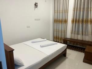 a bedroom with a bed and a cross on the wall at Mirissa Royal Ace in Mirissa