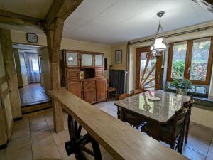 a kitchen and dining room with a table and chairs at Gîte chaleureux en pleine nature avec terrasse, idéal pour randonnées et vététistes, proche de Gérardmer - FR-1-589-125 in Le Syndicat