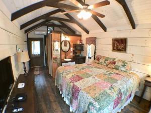 a bedroom with a bed and a ceiling fan at Cozy Cabin Near the Smokies #12 Carlotta in Sevierville