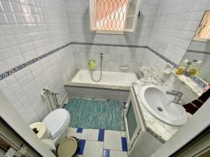 a small bathroom with a sink and a toilet at Omnia House in Monastir