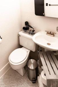 a bathroom with a toilet and a sink at Trailside Retreat in the City in Tulsa