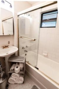 a bathroom with a shower and a sink and a toilet at Trailside Retreat in the City in Tulsa