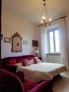 a bedroom with a large bed and a mirror at CASA MARIA Castel del Piano appartamento vista montagna in zona centrale in Castel del Piano