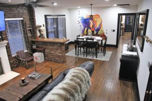 a living room with a couch and a dining room at Bison Flat - Redefined Urban Luxury in Tulsa