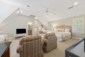 a large bedroom with two beds and a flat screen tv at 2482 High Hammock Road in Seabrook Island