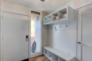 a room with a white wall with shelves and a door at 1172 Beach Walker in Amelia Island