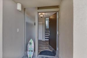 a surfboard leaning against a wall next to a door at 1172 Beach Walker in Amelia Island