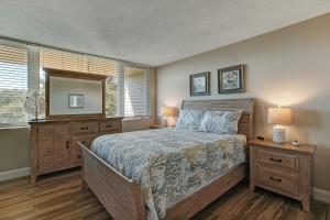 a bedroom with a bed and a mirror and a window at 1172 Beach Walker in Amelia Island