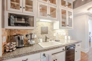 a kitchen with a sink and a microwave at The T-town Yorkshire Flat in Tulsa