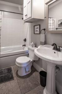 a bathroom with a white toilet and a sink at The T-town Yorkshire Flat in Tulsa