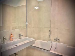 a white bathroom with a sink and a shower at Wiedner Apartments in Vienna