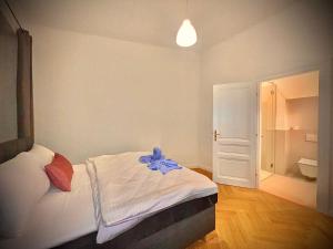 a bedroom with a bed with a blue robe on it at Wiedner Apartments in Vienna