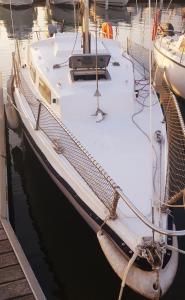 a white boat is docked in the water at Nuit insolite in Le Barcarès