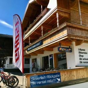 une moto garée devant un restaurant de location de skis dans l'établissement Ferienwohnung Neubau, à Alpbach